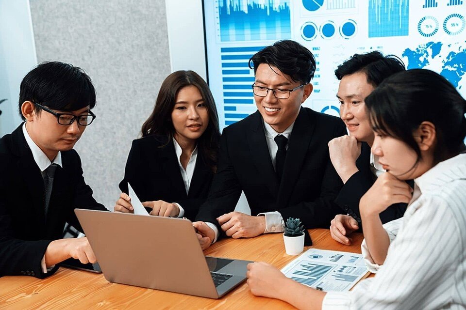 The Top Finance Solution team reviewing loan applications together in the office